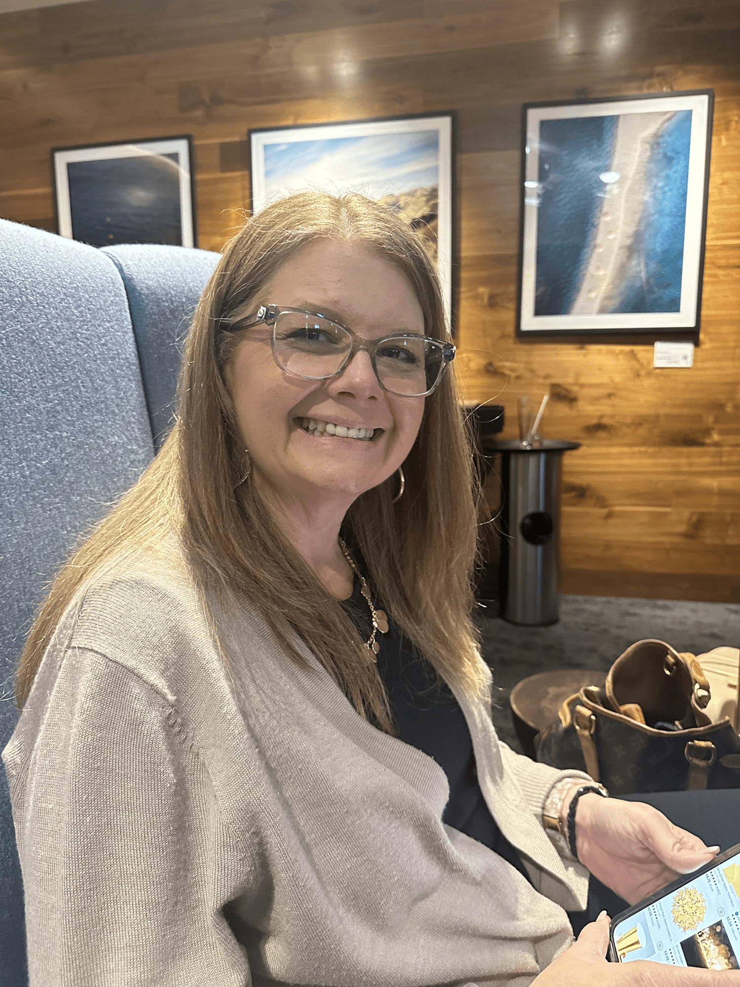 Personal Travel Planner Brandie relaxing in the peaceful environment of an airport lounge, waiting for her next flight to somewhere fun