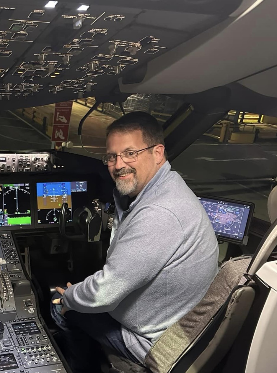 Personal Travel Planner John sitting in the cockpit of a British Airways 787 after arriving in London refreshed from sitting in business class