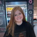 Customer Hannah H in closeup, who loves how our itinerary app makes her expertly planned travel days very easy to follow